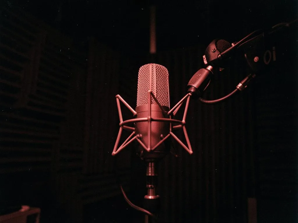 Studio microphone under red light in the Velvet vocal booth